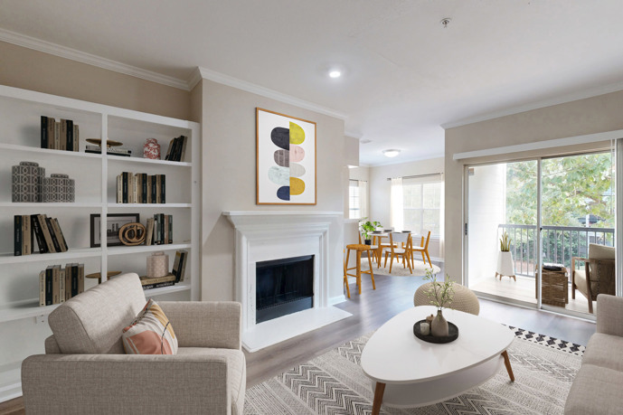 The living room of a unit at Reflections on Sweetwater, showcasing a spacious layout, comfortable seating, and elegant decoration.